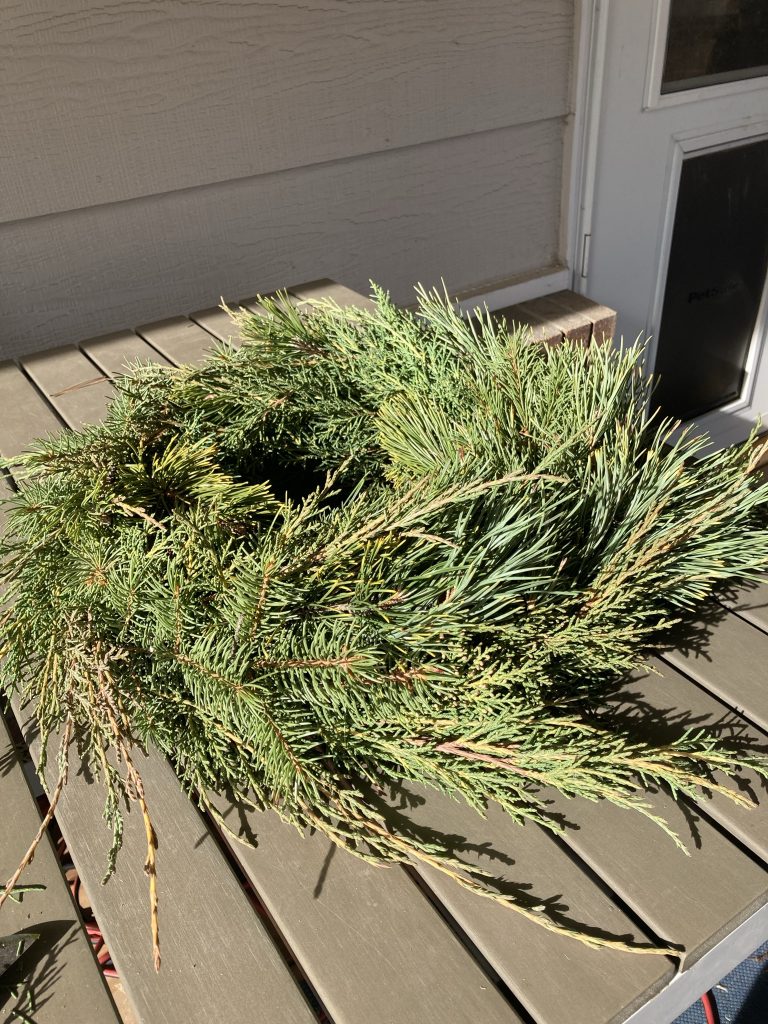 The wreath completely covered with greenery